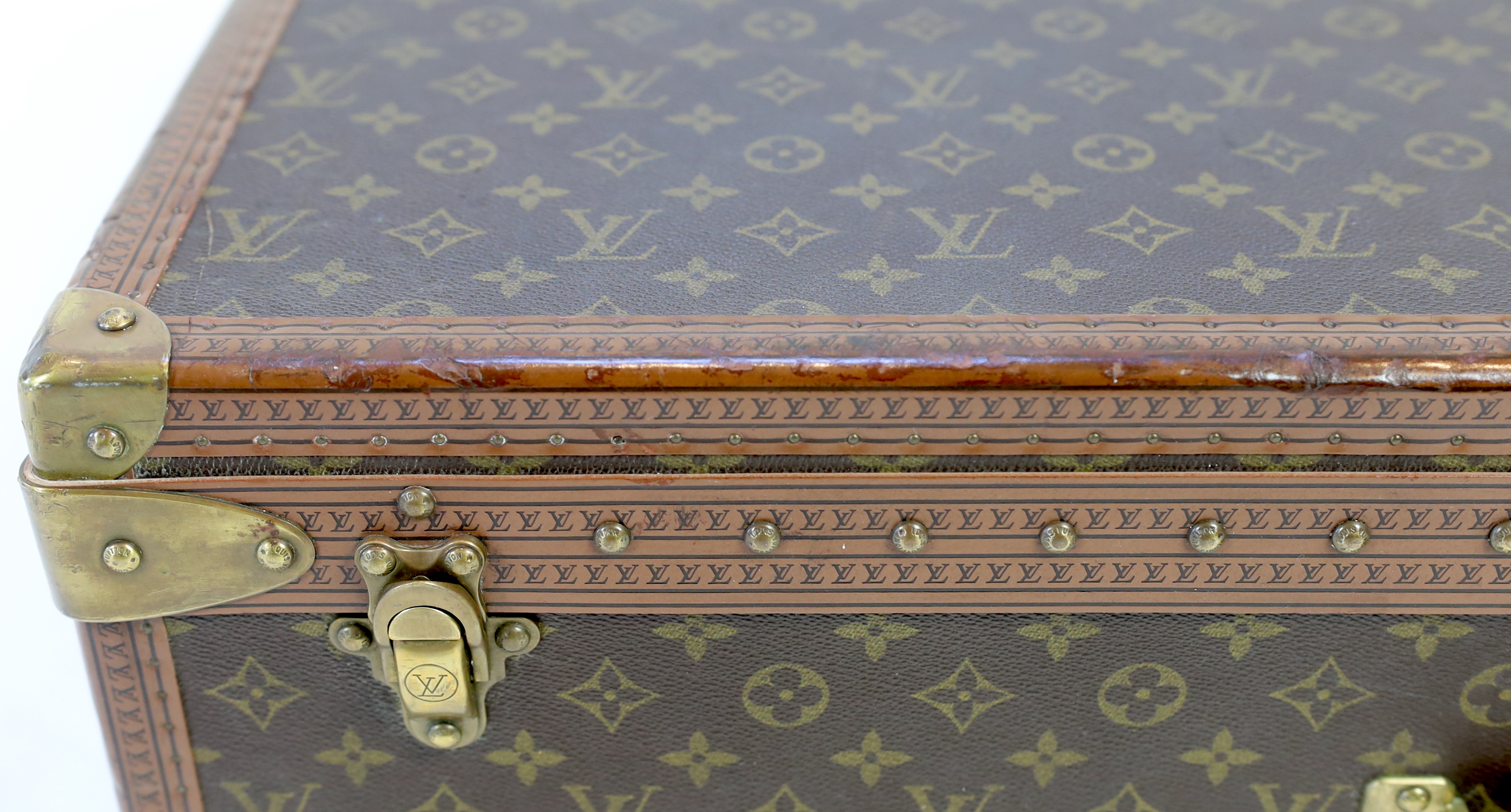 A Louis Vuitton monogram canvas and tan leather suitcase, width 81cm, depth 26cm, height 52cm